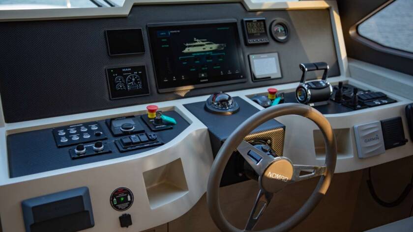 Luxury yacht helm with Garmin navigation and marine controls.