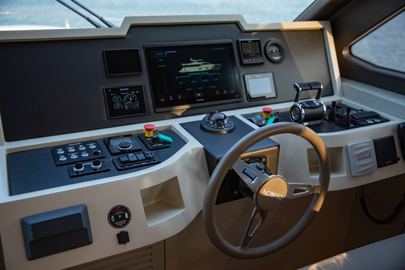 Luxury yacht helm with Garmin navigation and marine controls.